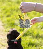 woman holding  poop bags for dogs 